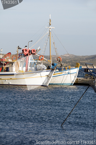 Image of fishing boats in harbor Adamas Milos Cyclades Greek island Greec