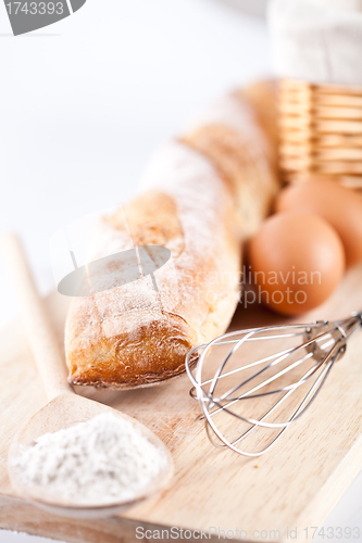 Image of bread, flour, eggs and kitchen utensil