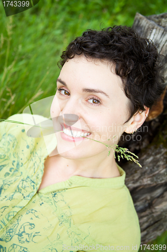 Image of cute girl on green field 