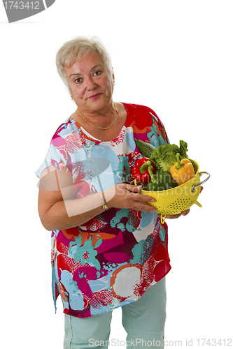Image of Female senior with fresh vegetables