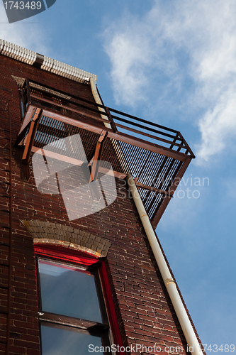 Image of Fire escape on brick building from below