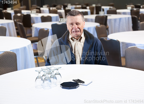 Image of Man crying in empty conference room