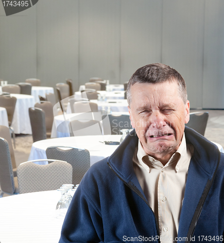 Image of Man crying in empty conference room