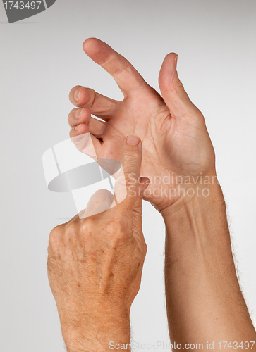 Image of Male hand holding invisible smartphone