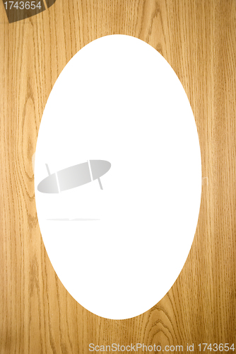 Image of Isolated white oval on wood imitation background 
