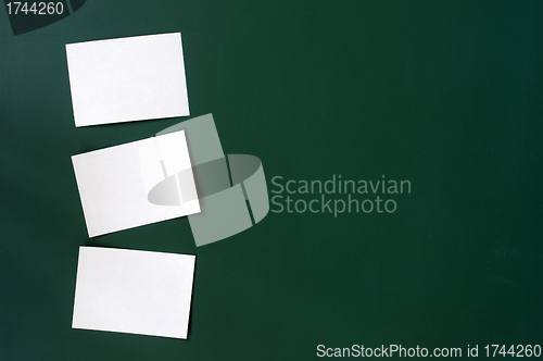 Image of Blank stick note on a green board