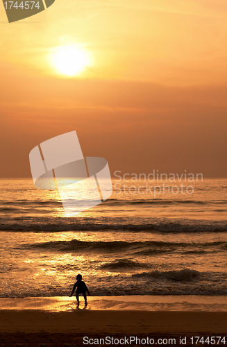 Image of Child plays on the evening beach