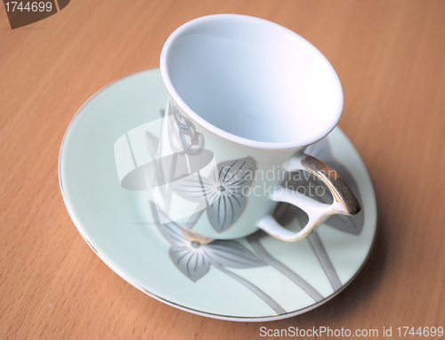 Image of empty cup and saucer  with pattern  