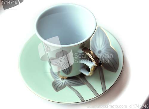 Image of empty cup and saucer  with pattern  
