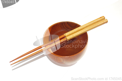 Image of Chopsticks with wooden bowl isolated on white 