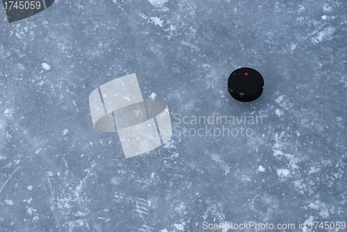 Image of ice rink surface with a puck