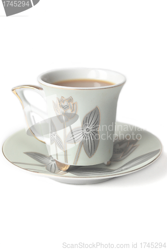 Image of cup of coffee with milk or cream and saucer 