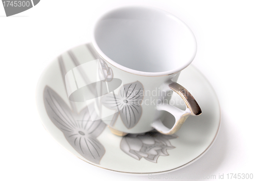 Image of empty cup and saucer  with pattern  