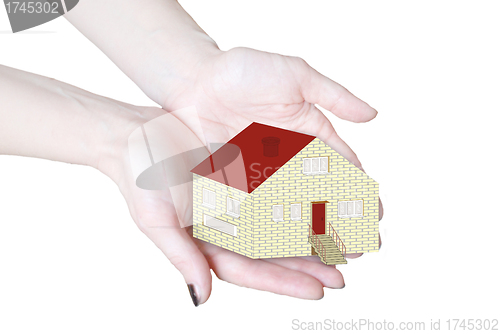 Image of The house in human hands isolated in white