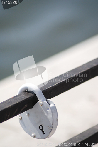 Image of metal lock of love on an iron structure