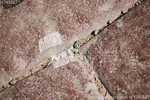 Image of texture of red paving stone close up