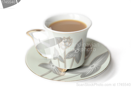 Image of cup of coffee with milk or cream and saucer 