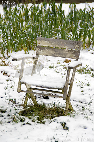 Image of Chair in the snowy vegetable garden