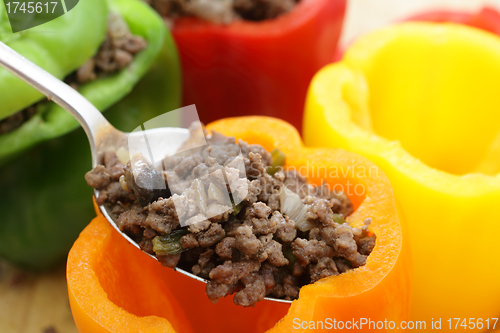 Image of Stuffing colourful peppers horizontal