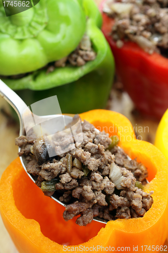 Image of Stuffing colourful peppers vertical
