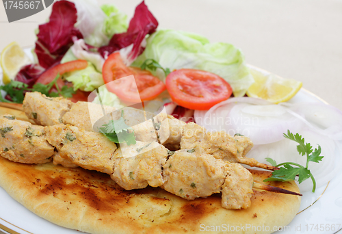 Image of Chicken tikka kebab meal side view