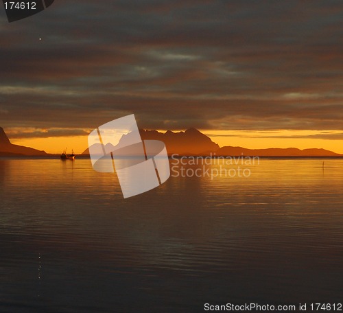 Image of Boat in sunset on the fjord