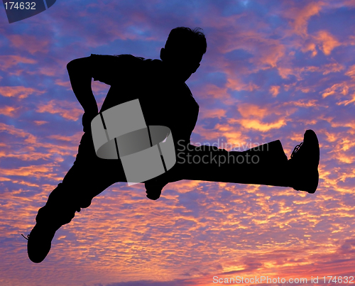 Image of Boy jumping high in the air