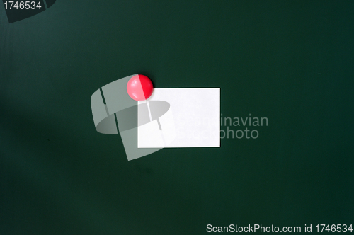 Image of Blank stick note on a green board
