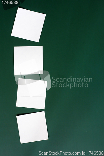 Image of Blank stick note on a green board