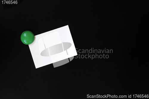 Image of Blank stick note on a blackboard