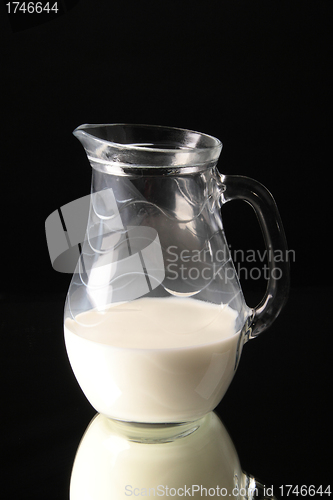 Image of Glass jug with milk on black background