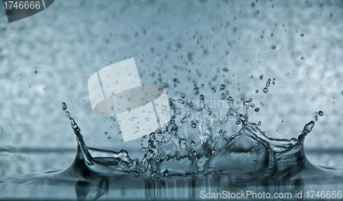 Image of Sparks of blue water on a gray background