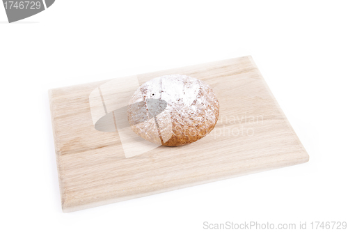 Image of The fresh bun isolated on wooden plate