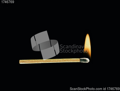 Image of Burning match on a black background