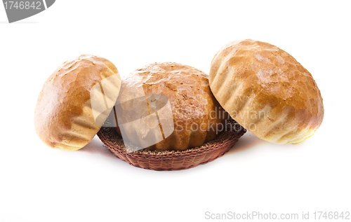 Image of three fresh baked rolls in a basket on white