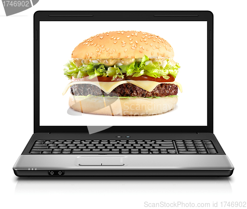 Image of Laptop computer close-up with cheeseburger