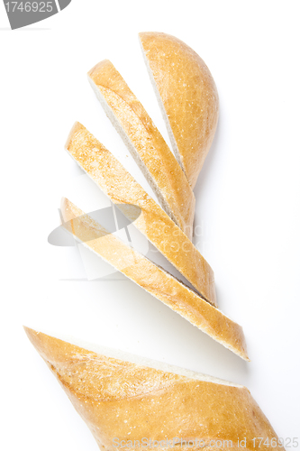 Image of Fresh baguette, sliced, isolated on white background