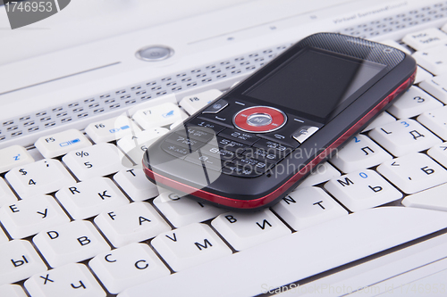 Image of Business concept - mobile phone over laptop keyboard
