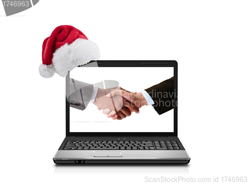 Image of Business people shaking hands in laptop