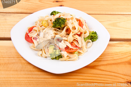 Image of pasta salad and broccoli on white plate