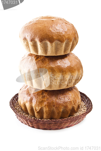 Image of fresh baked rolls with grain in a basket on white