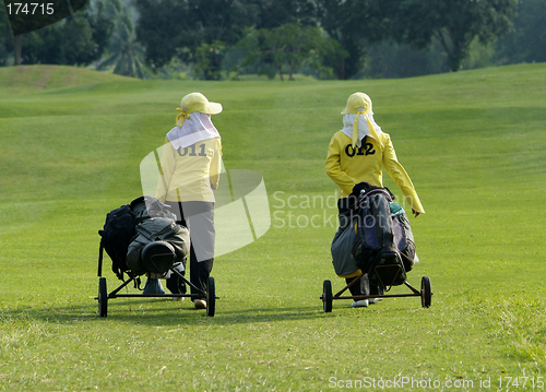Image of Two caddies on a golf course