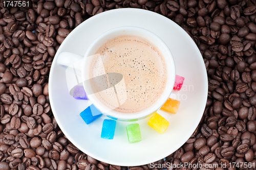 Image of Multicolored slabs of shugar and cup of coffee