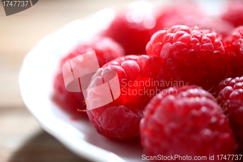Image of clean plate with fresh raspberries
