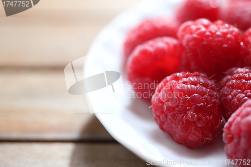 Image of clean plate with fresh raspberries