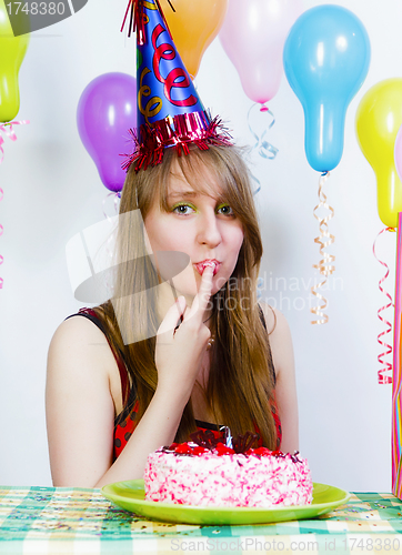 Image of Birthday. A young attractive girl eating cake