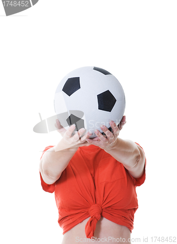 Image of woman holding soccer ball in front of her face