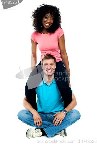 Image of Girlfriend riding on her mans shoulder