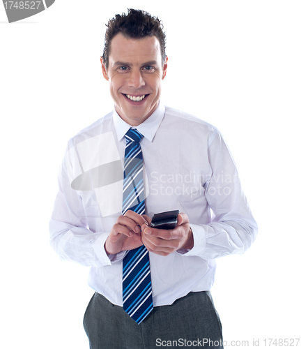 Image of Smiling business professional messaging