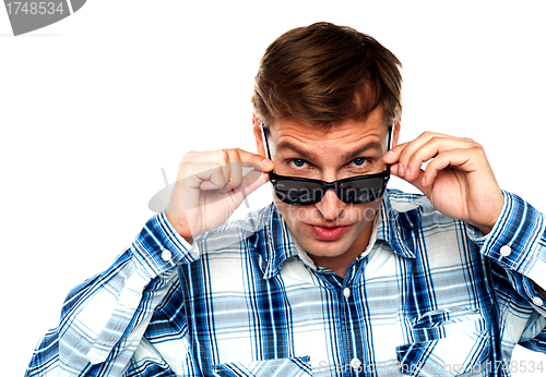 Image of Confident young man peeping from goggles